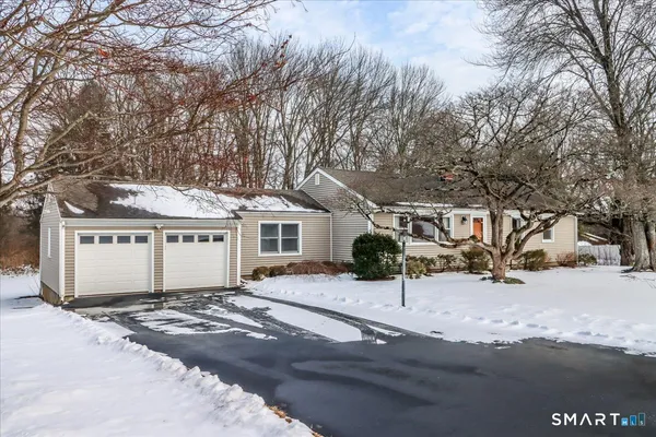 a house with a tree covered in the snow