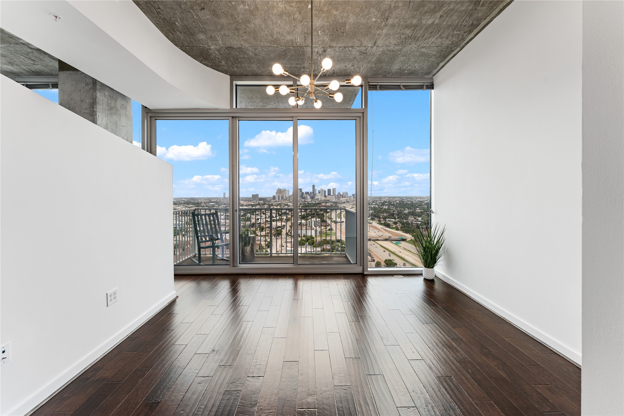 5925 Almeda Road, Unit 12711 Houston, TX 77004 - Photo 4 of 34 The living room offers warm flooring with cool concrete ceiling.
