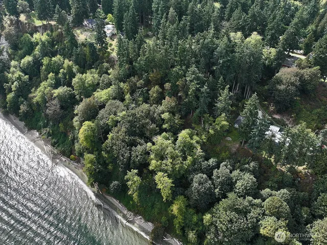 an aerial view of a houses with a yard
