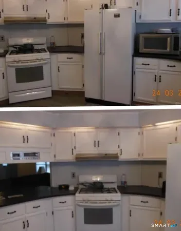 a kitchen with stainless steel appliances a stove and a microwave