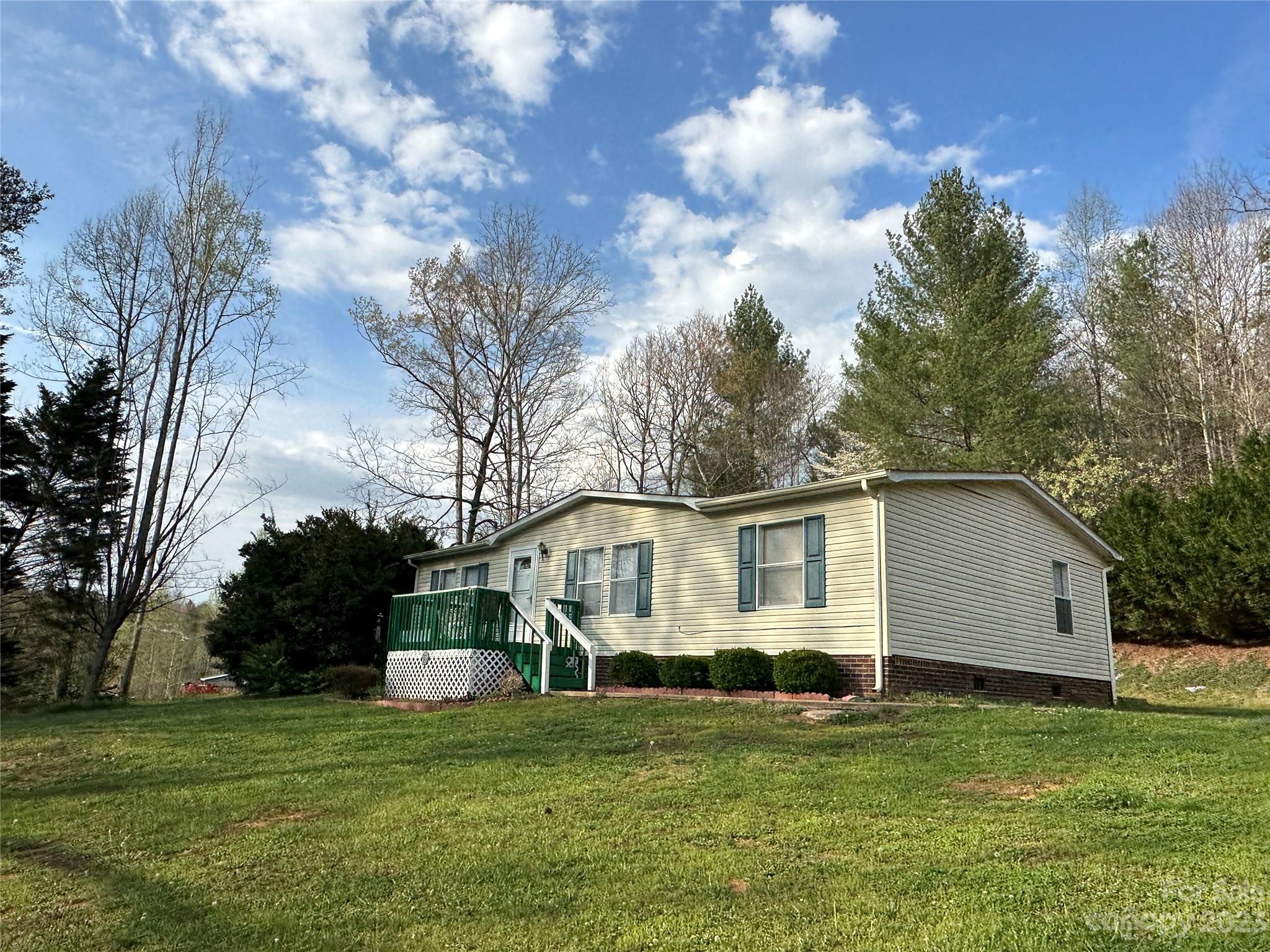 a white house that has a tree in front of it