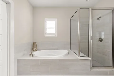 a bathroom with a tub and shower