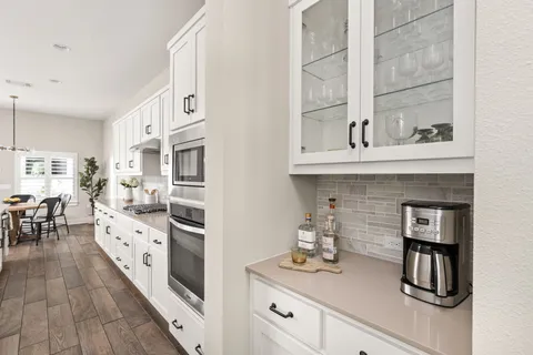 an open kitchen with a sink and cabinets