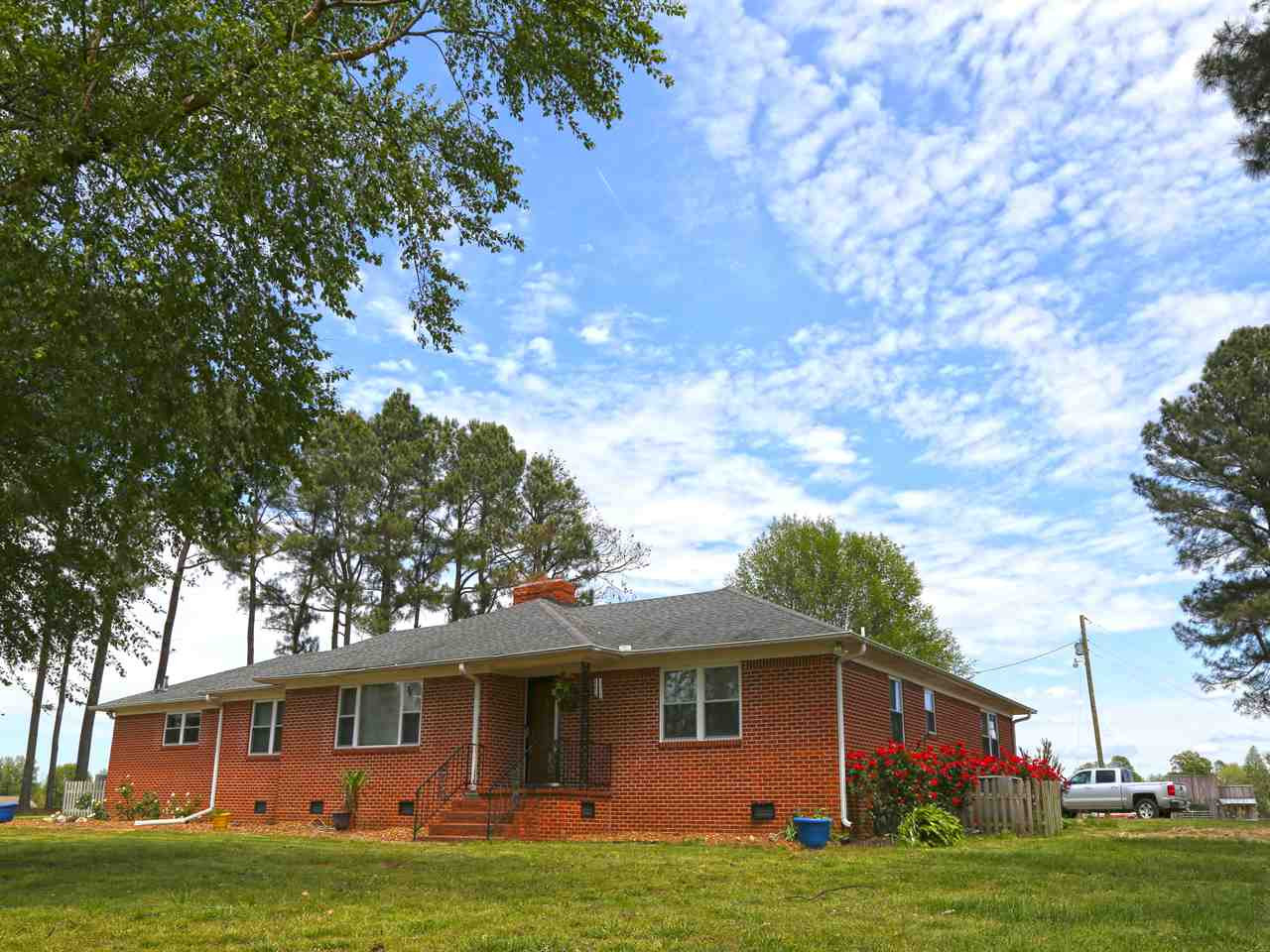 2620 Union Cross Road Lexington, TN 38351 - Photo 1 of 1 a front view of a house with a garden and trees