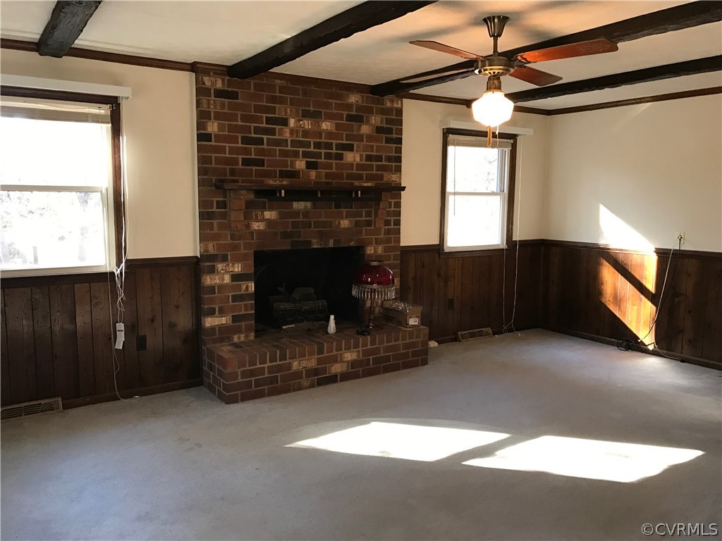 4614 Tatum Road Disputanta, VA 23842 - Photo 3 of 7 a living room with furniture a fireplace and a flat screen tv