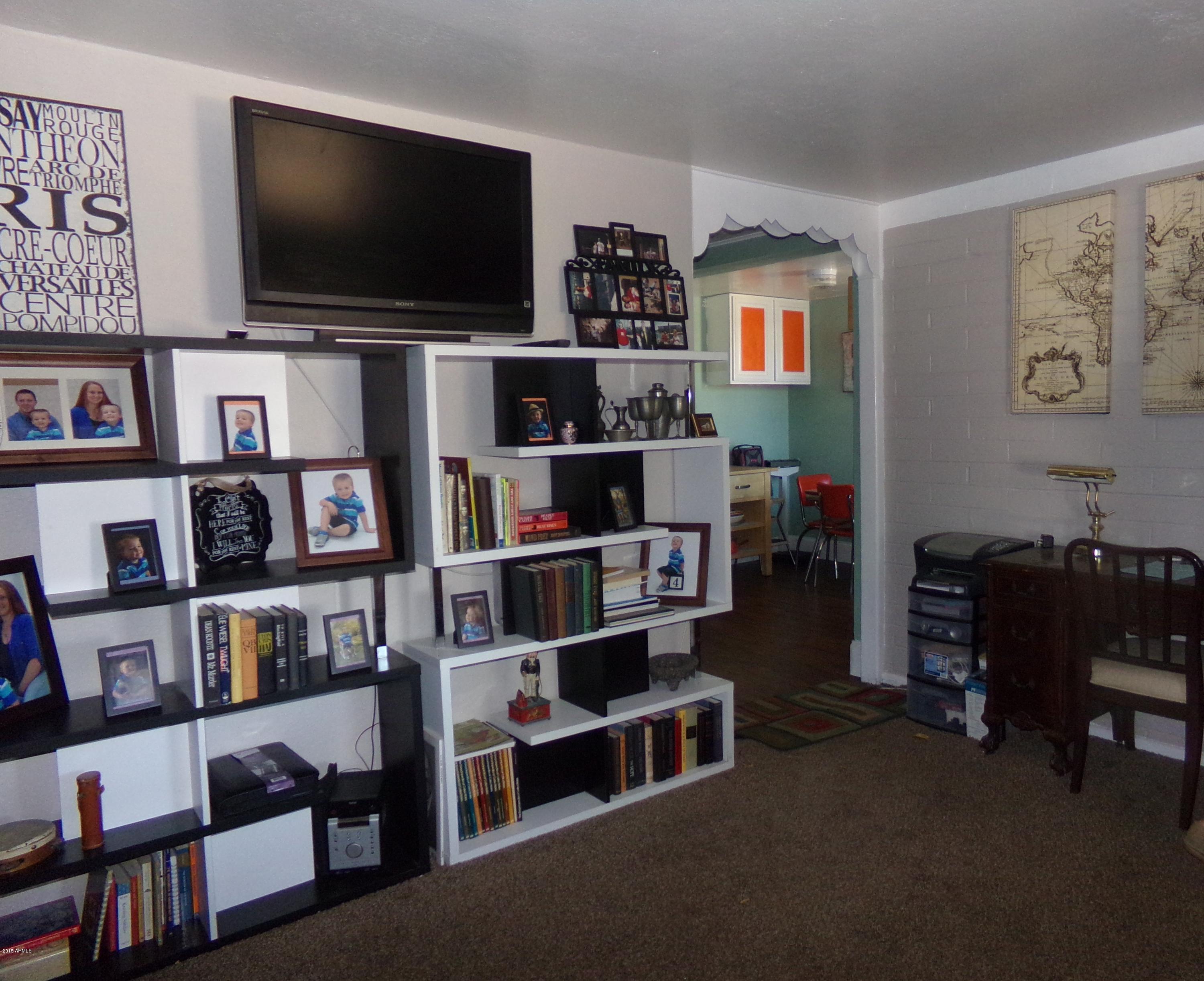 1221 West Mountain View Road Phoenix, AZ 85021 - Photo 3 of 12 a living room with furniture and a flat screen tv