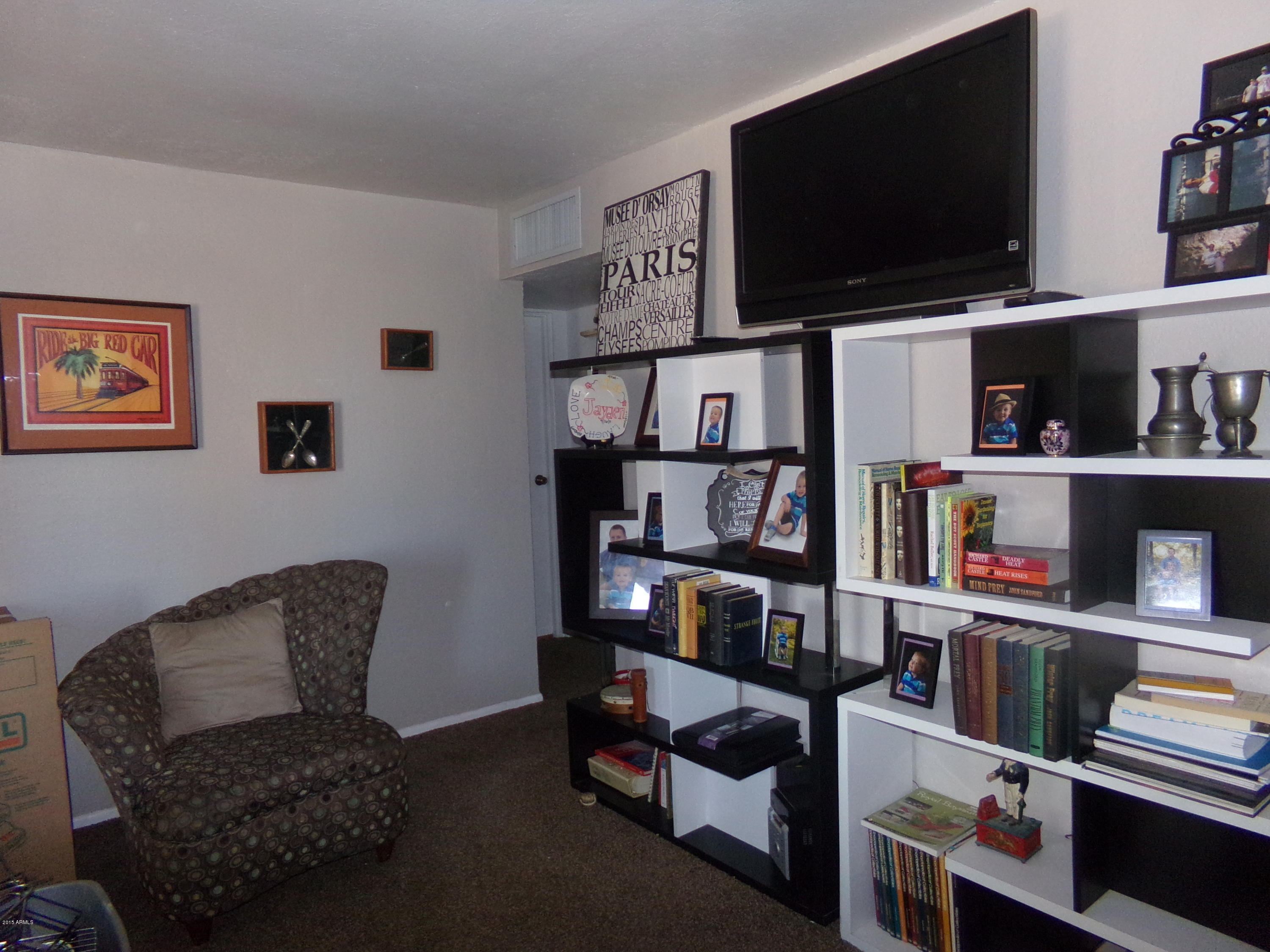 1221 West Mountain View Road Phoenix, AZ 85021 - Photo 4 of 12 a living room with furniture and a flat screen tv