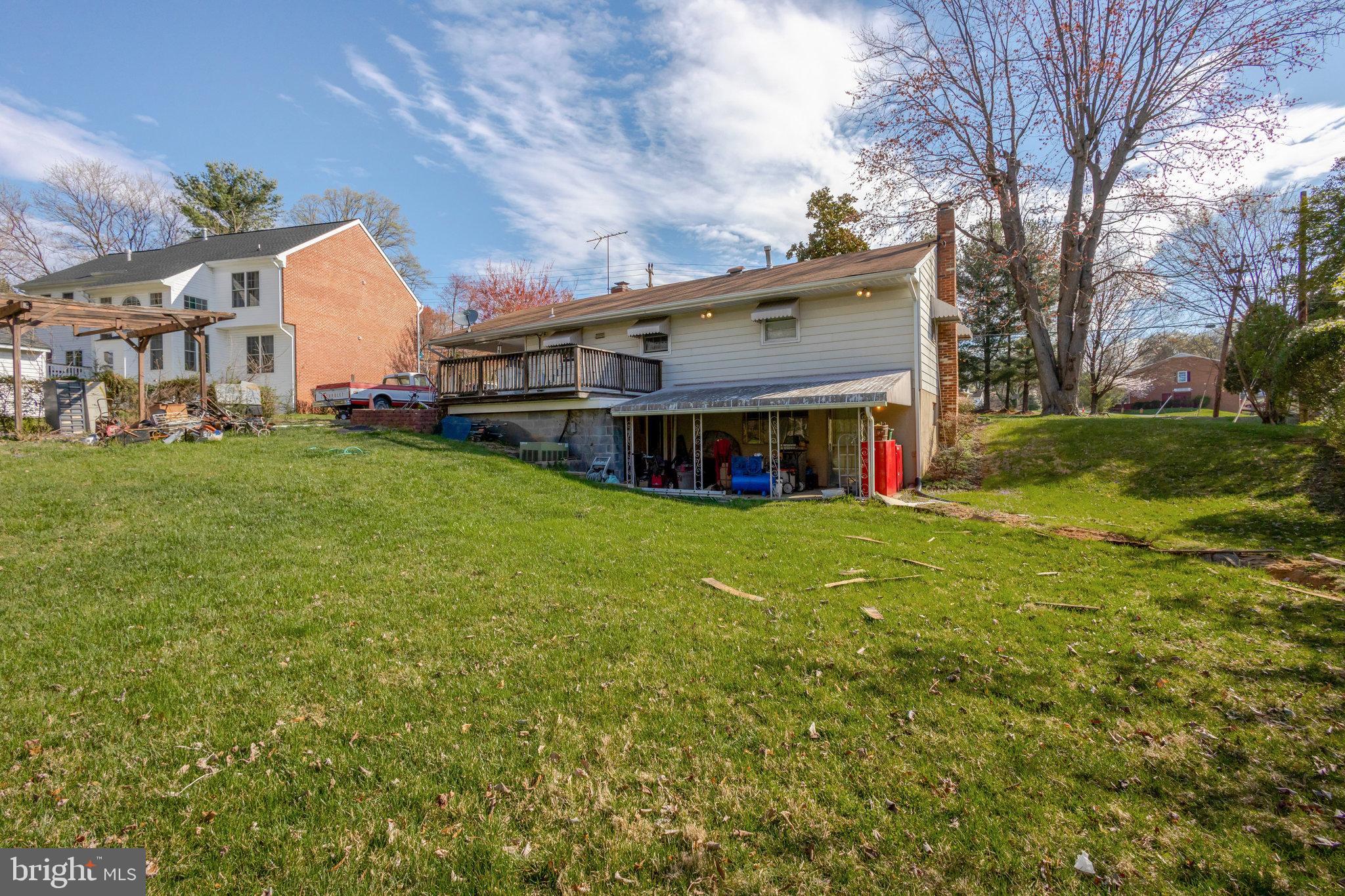 5008 Backlick Road Annandale, VA 22003 - Photo 11 of 14 a view of a house with a big yard and large tree