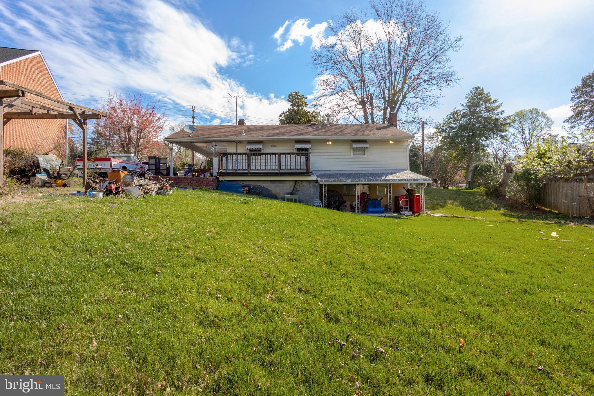 5008 Backlick Road Annandale, VA 22003 - Photo 9 of 14 a view of a house with a big yard and large trees