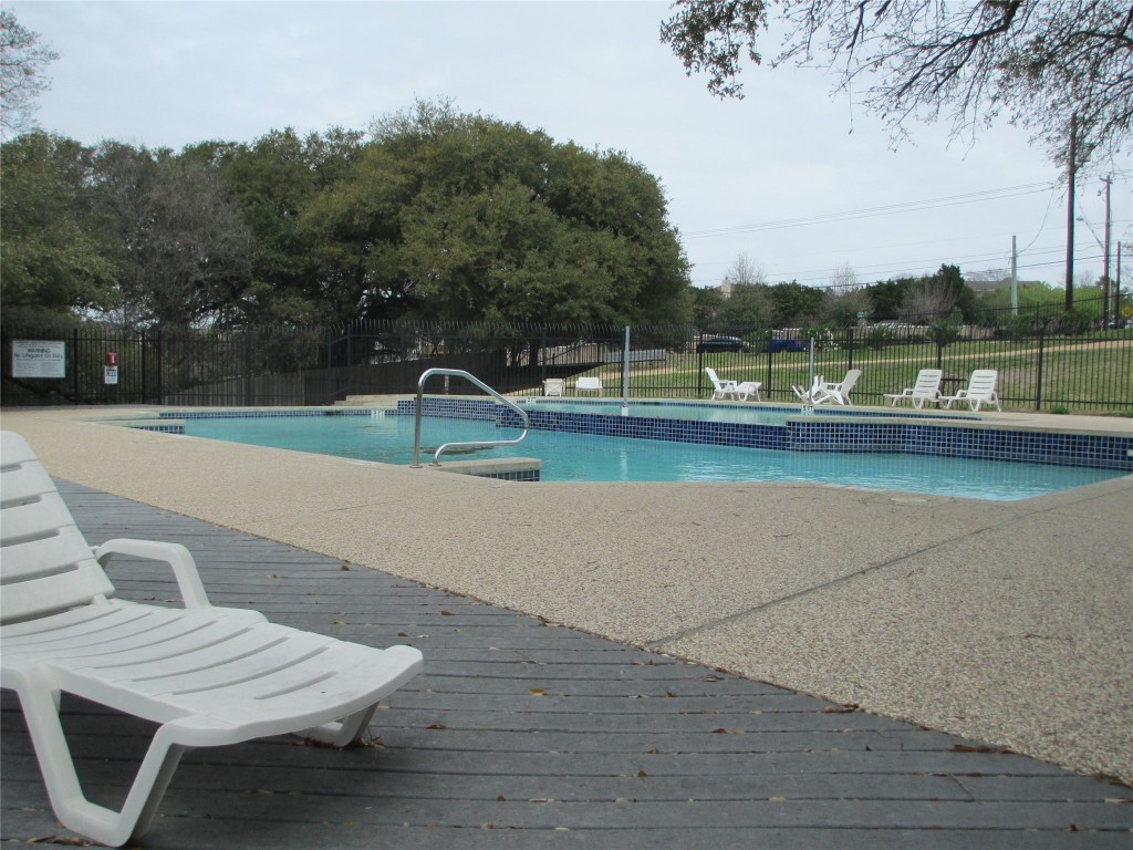 1015 East Yager Lane, Unit 69 Austin, TX 78753 - Photo 14 of 16 a view of swimming pool with lounge chair and trees