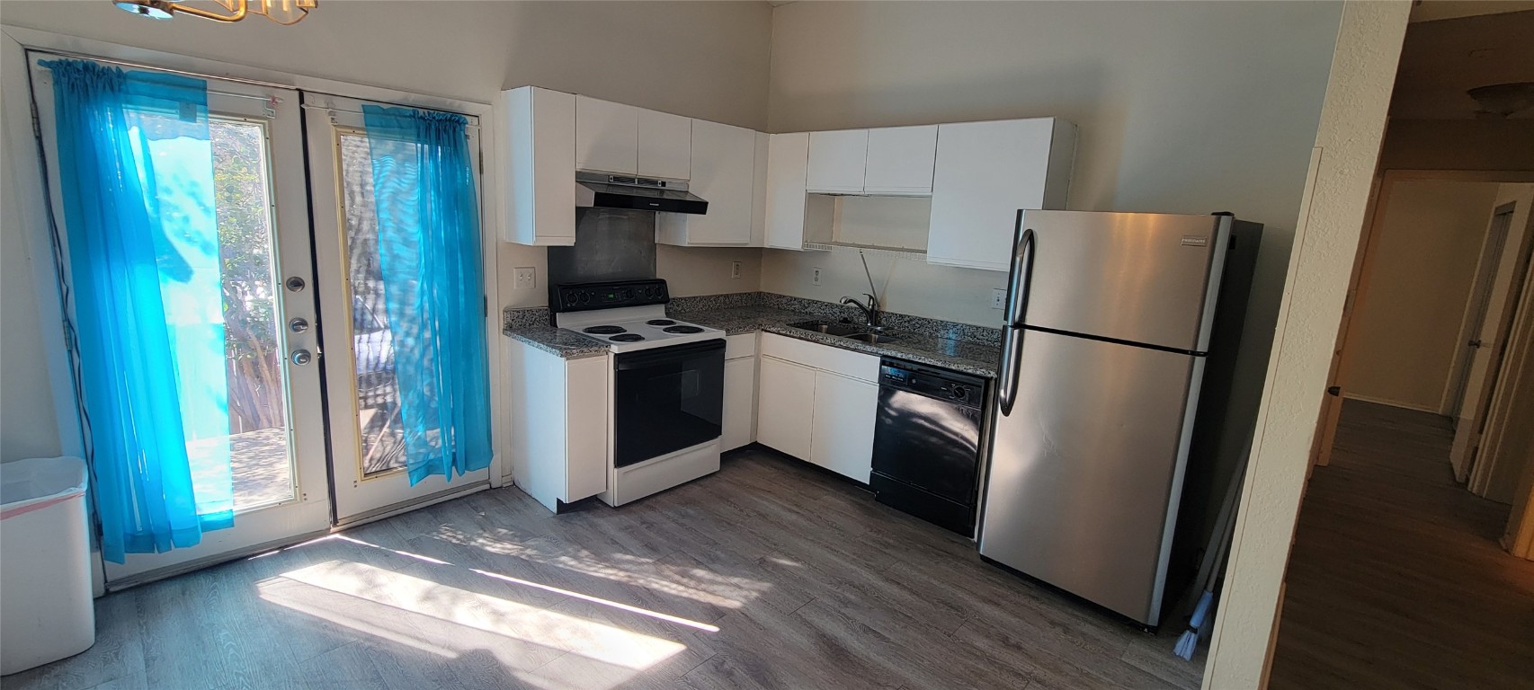 1015 East Yager Lane, Unit 69 Austin, TX 78753 - Photo 3 of 16 a kitchen with stainless steel appliances granite countertop a refrigerator stove and sink