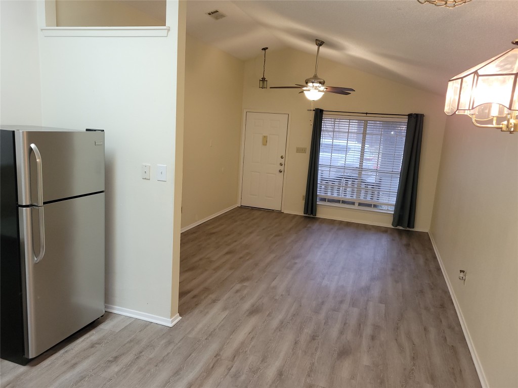 1015 East Yager Lane, Unit 69 Austin, TX 78753 - Photo 16 of 16 an empty room with wooden floor a ceiling fan and windows