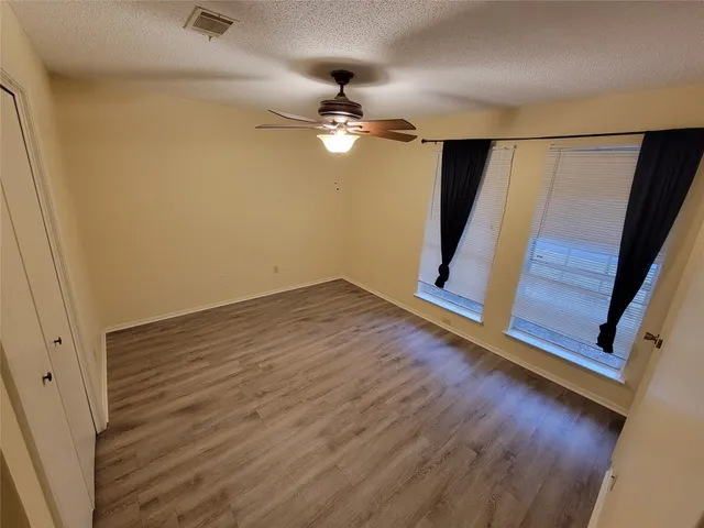 a view of wooden floor and chandelier in a room