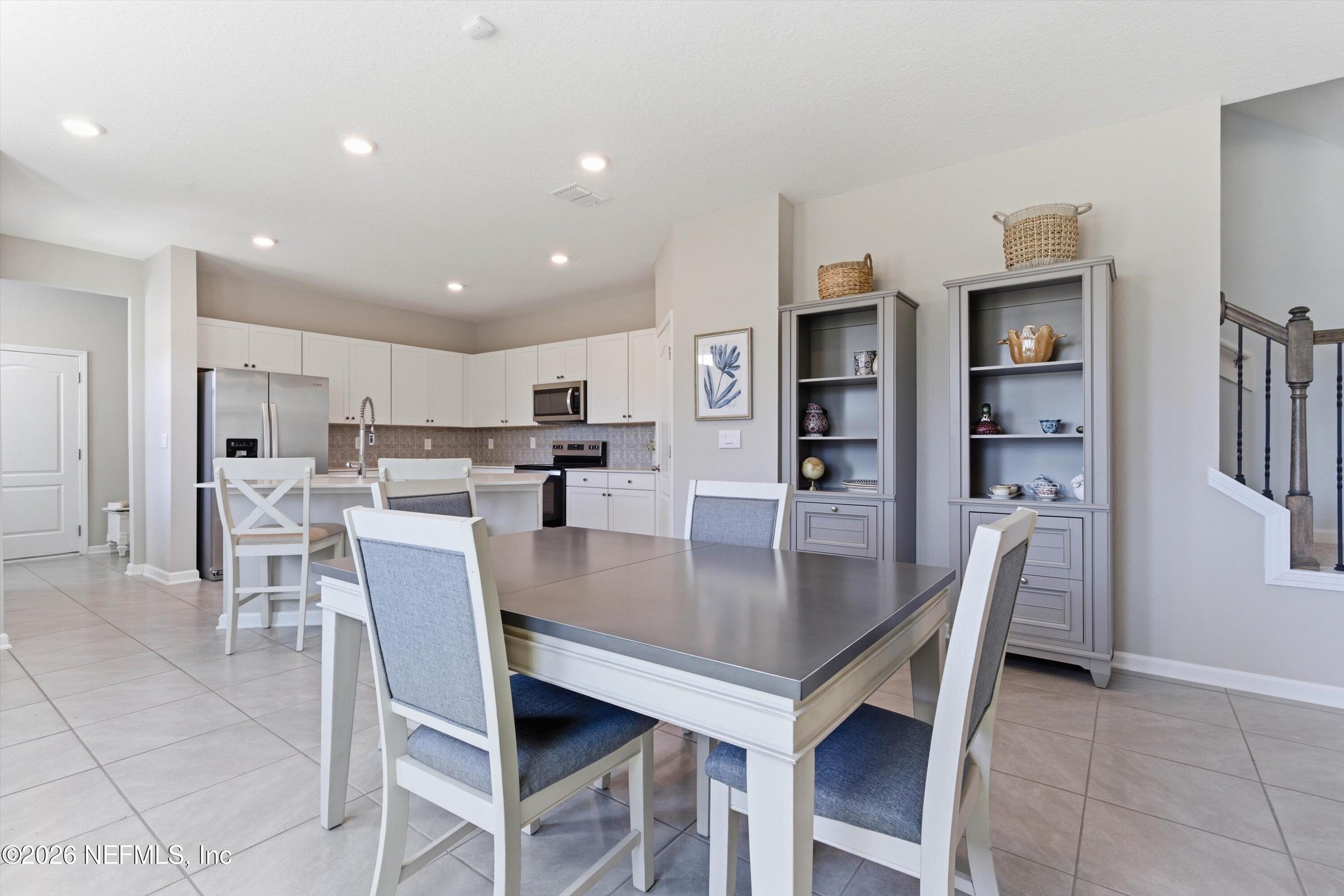 103 Seaport Breeze Road St. Augustine, FL 32095 - Photo 11 of 44 a view of a dining room and livingroom with furniture