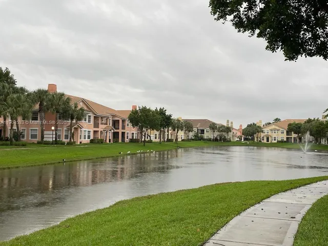 a view of a lake with houses in the back