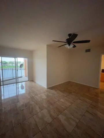 a view of an empty room and a window