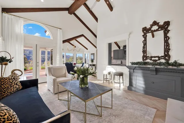 a view of living room kitchen with furniture and large windows
