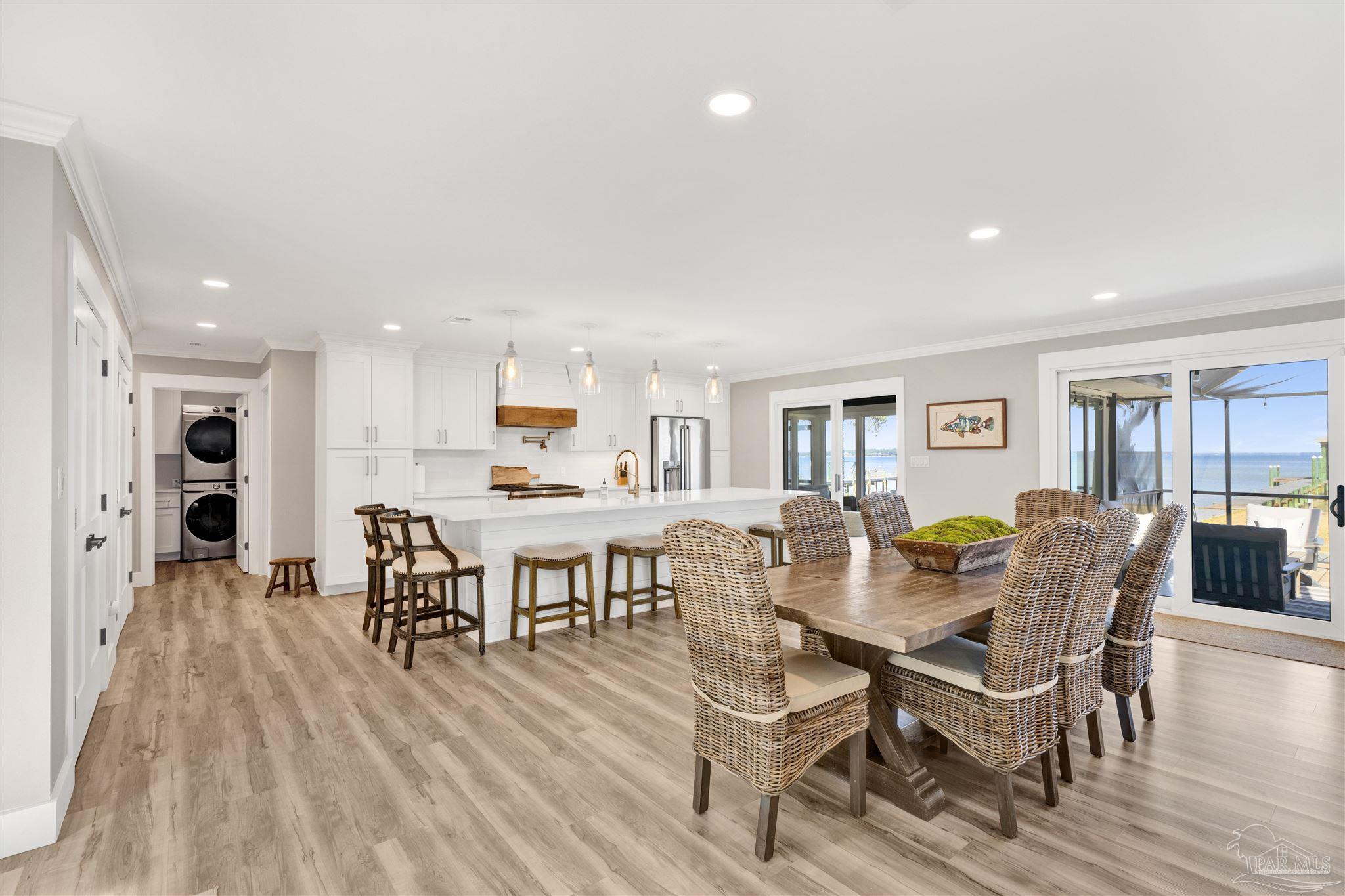 5470 North Shore Road Pensacola, FL 32507 - Photo 18 of 63 a view of a dining room with furniture and wooden floor
