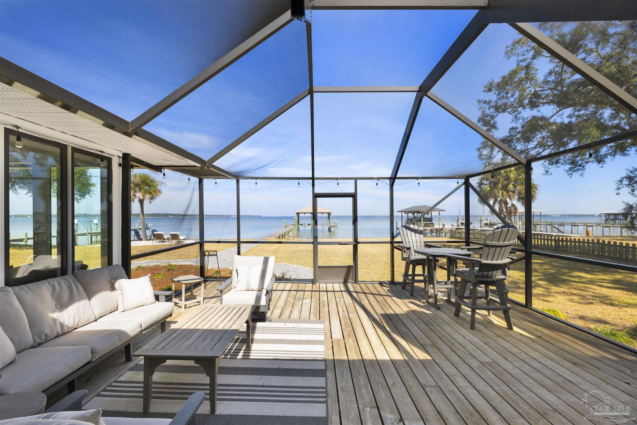 5470 North Shore Road Pensacola, FL 32507 - Photo 21 of 63 a view of balcony with furniture and wooden floor