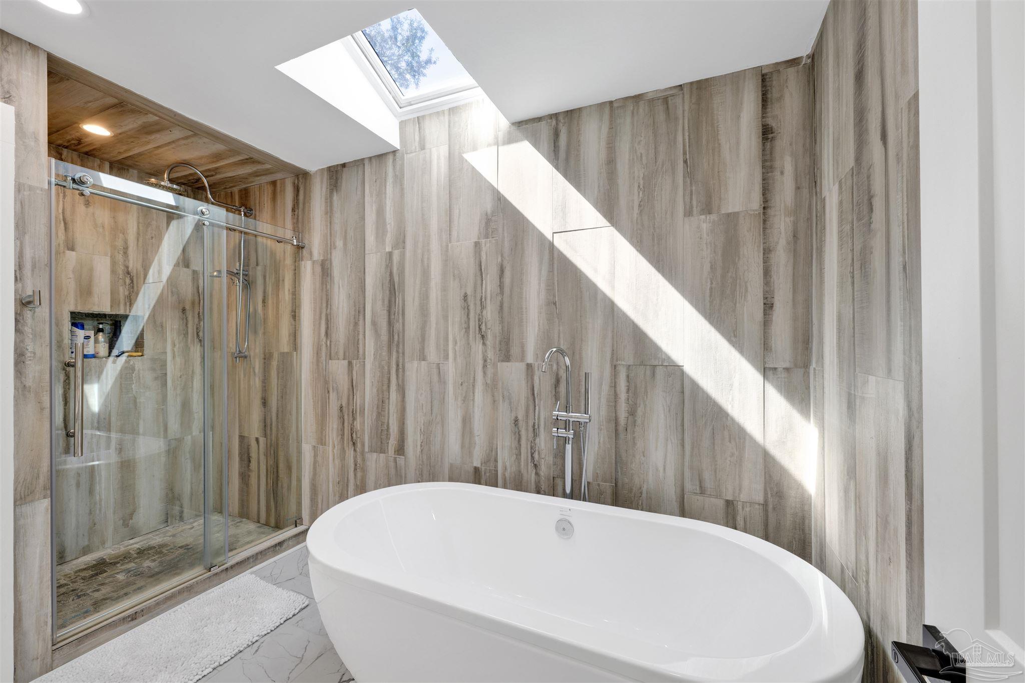 5470 North Shore Road Pensacola, FL 32507 - Photo 26 of 63 a bathroom with a white bath tub and shower