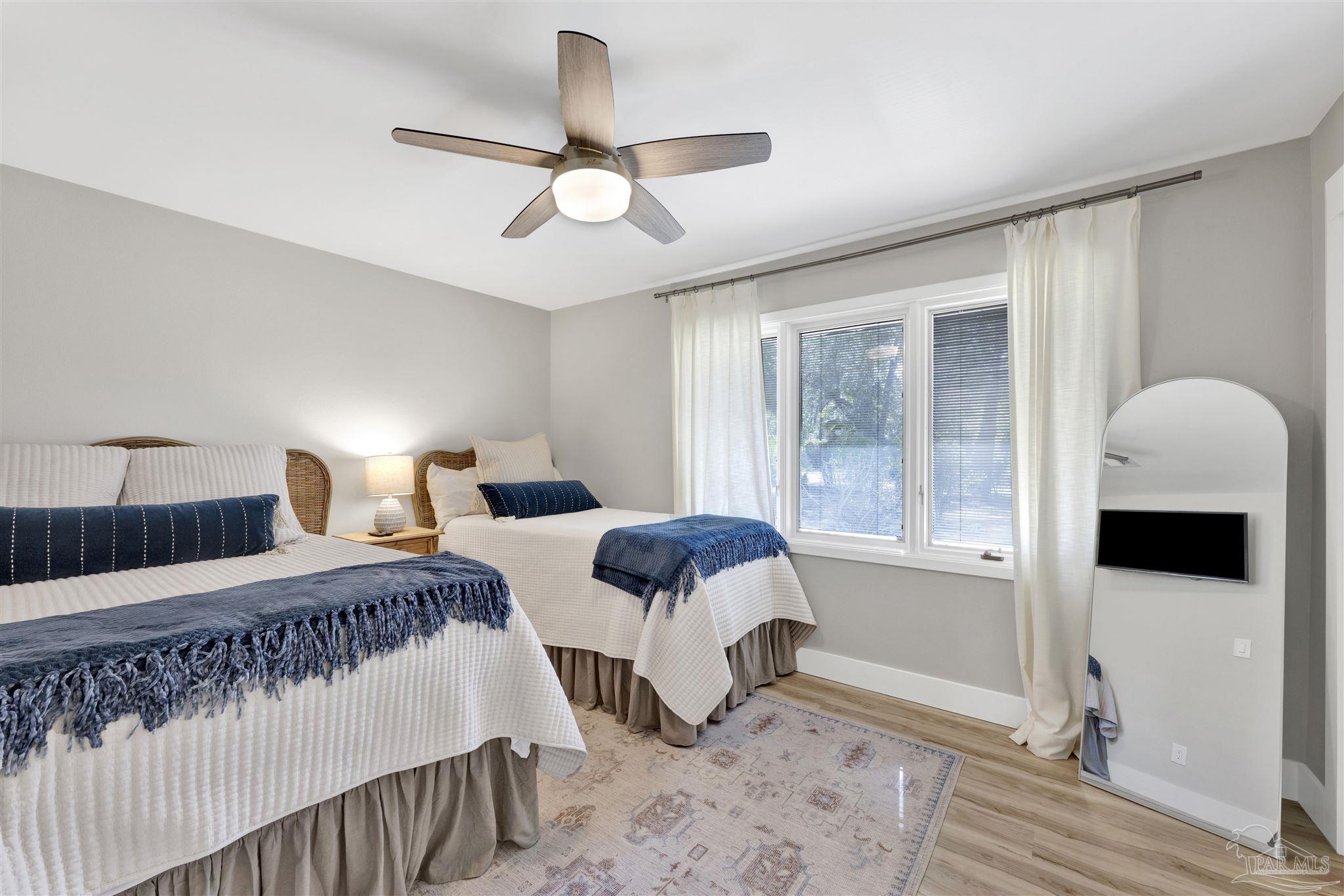 5470 North Shore Road Pensacola, FL 32507 - Photo 29 of 63 a bedroom with double bed and a window