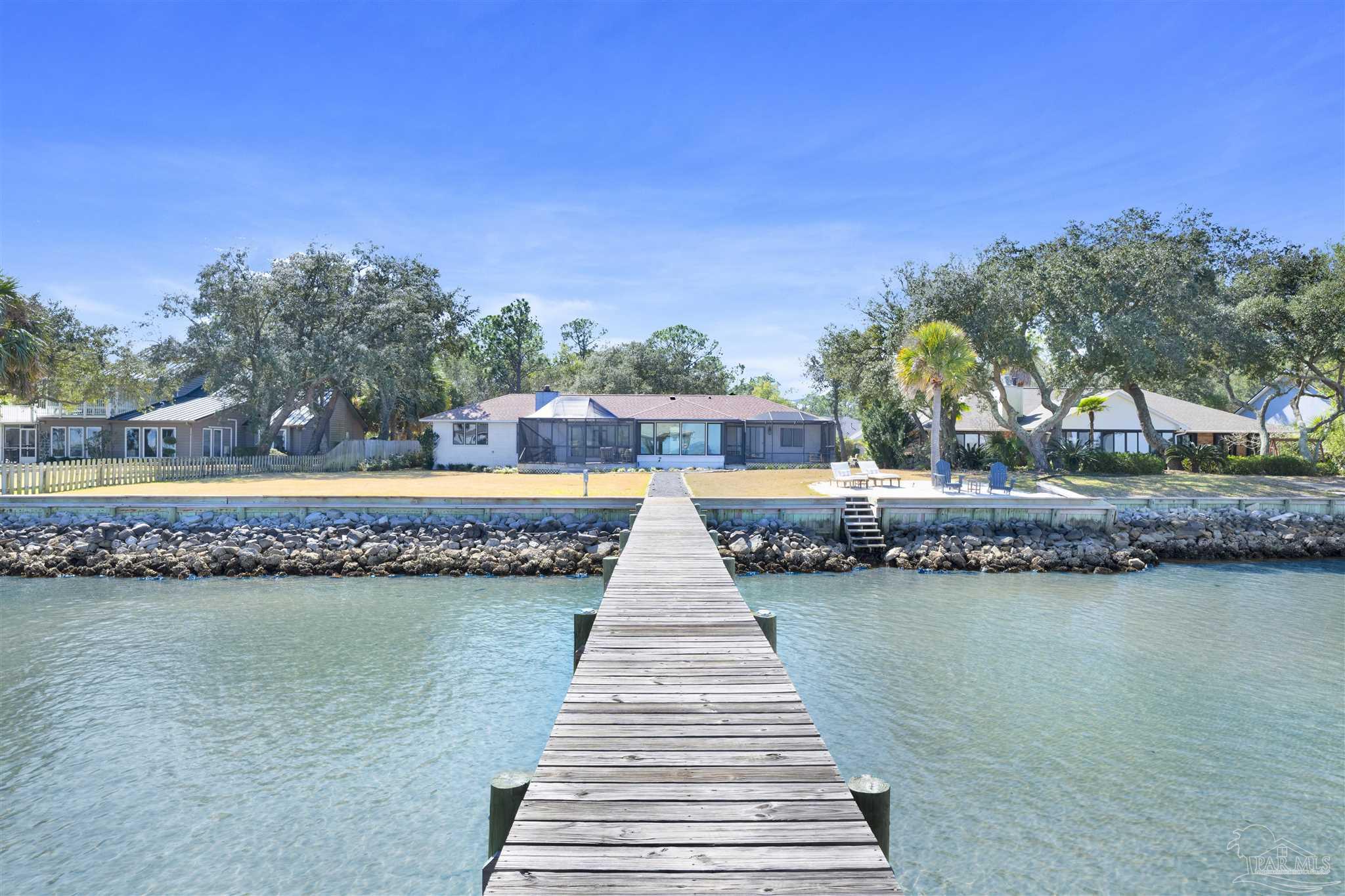 5470 North Shore Road Pensacola, FL 32507 - Photo 40 of 63 a front view of a house with a lake view