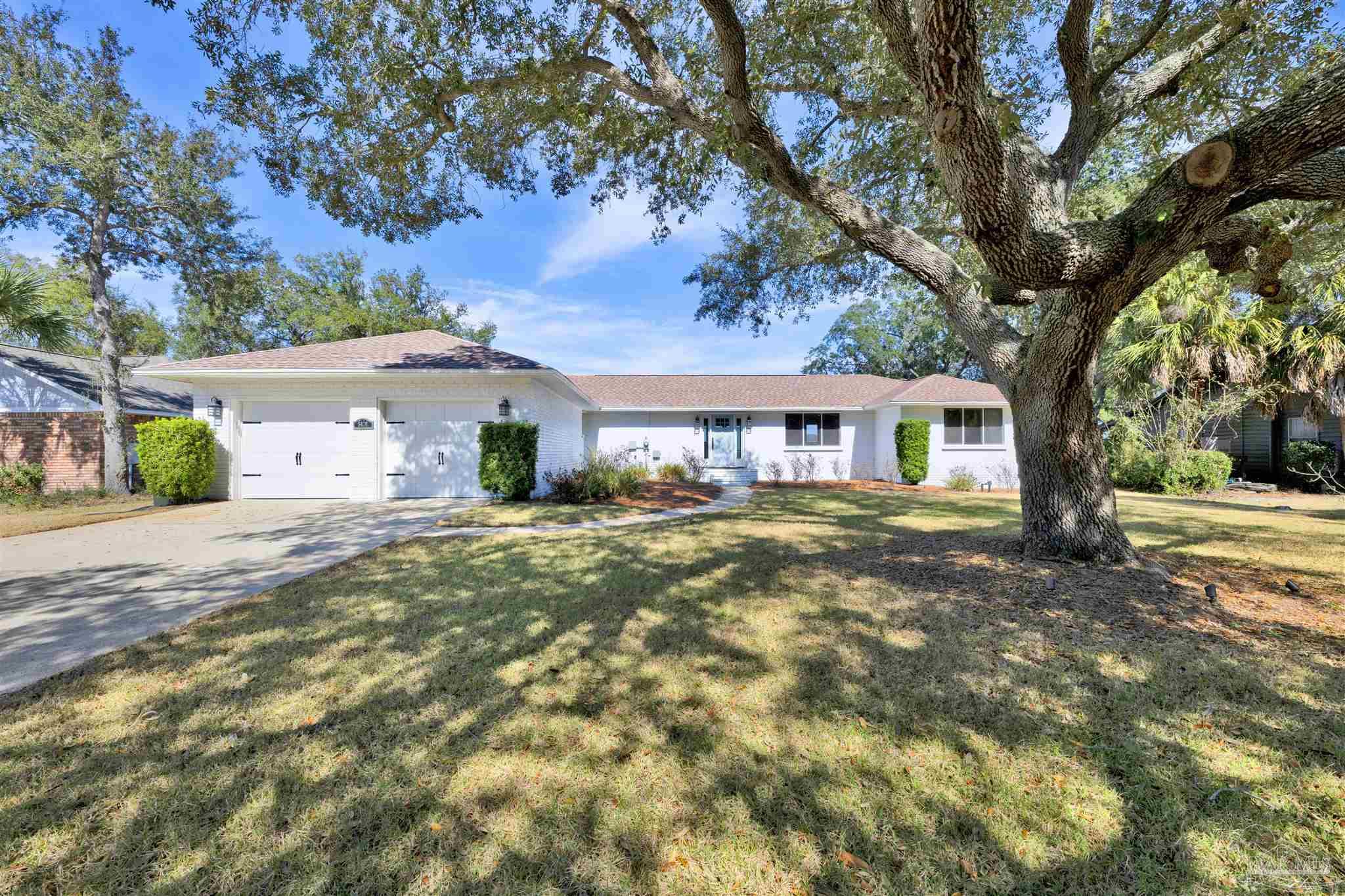 5470 North Shore Road Pensacola, FL 32507 - Photo 44 of 63 a front view of a house with a yard