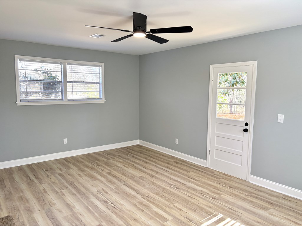 2502 13th Avenue Valley, AL 36854 - Photo 17 of 56 a view of an empty room with wooden floor and a window