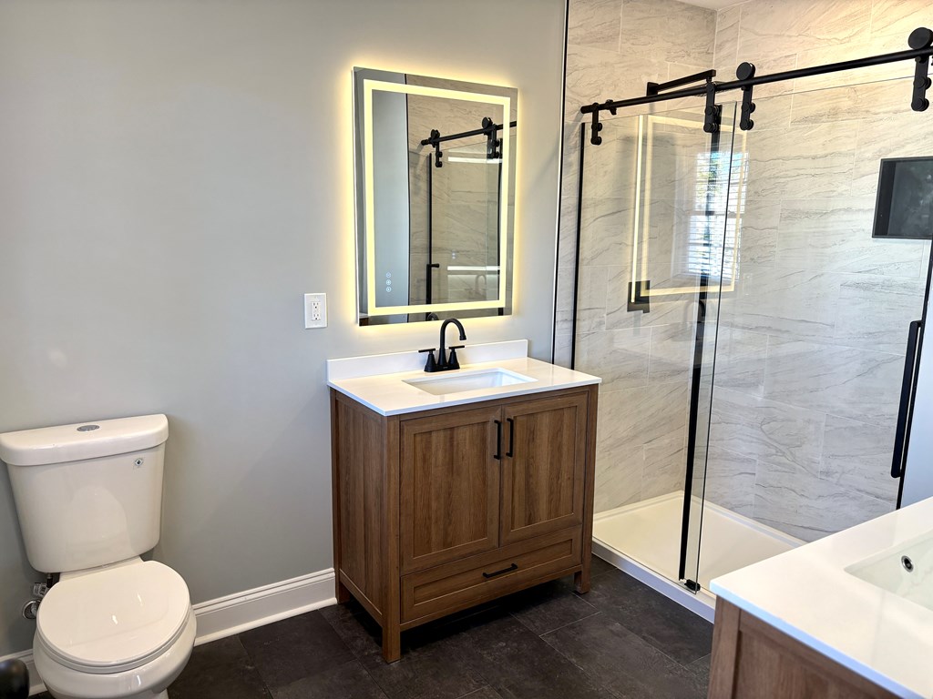 2502 13th Avenue Valley, AL 36854 - Photo 21 of 56 a bathroom with a sink a toilet and shower