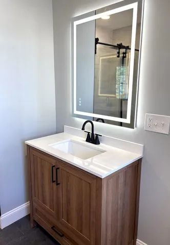 an empty room with a window and a ceiling fan