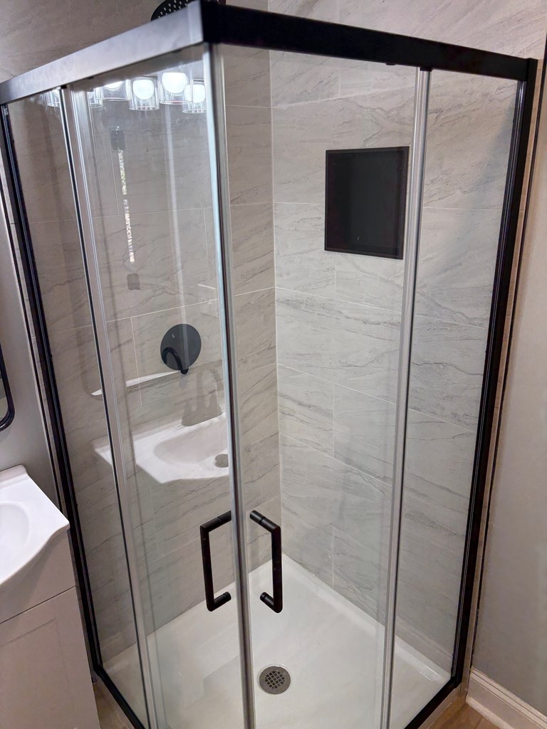 2502 13th Avenue Valley, AL 36854 - Photo 36 of 56 a bathroom with a shower and mirror