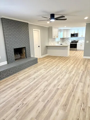 a large kitchen with kitchen island a sink stainless steel appliances and cabinets
