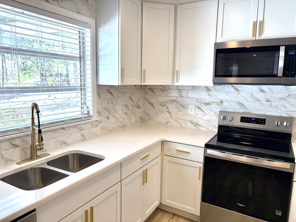 2502 13th Avenue Valley, AL 36854 - Photo 10 of 56 a kitchen with a sink stove and microwave