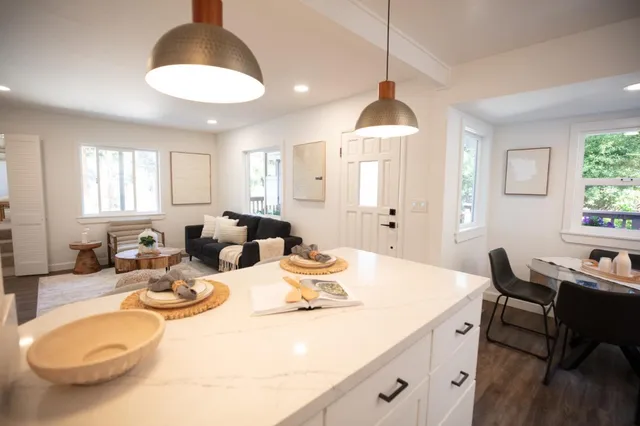 a living room with furniture wooden floor and a table