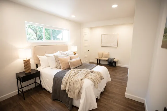 a bed room with a bed and a chair