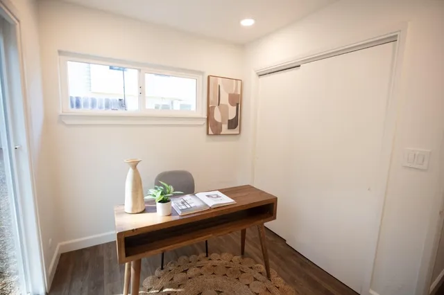 a view of a house with a yard and wooden fence