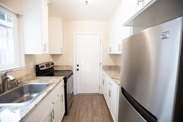 a kitchen with a sink stove and cabinets