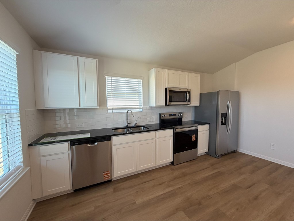 109 Honey Bee Road Jarrell, TX 76537 - Photo 8 of 10 a kitchen with granite countertop a refrigerator stove top oven and sink