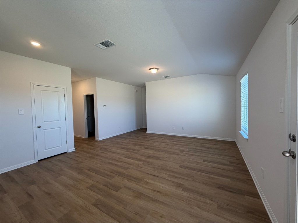 109 Honey Bee Road Jarrell, TX 76537 - Photo 9 of 10 a view of an empty room with wooden floor and a window