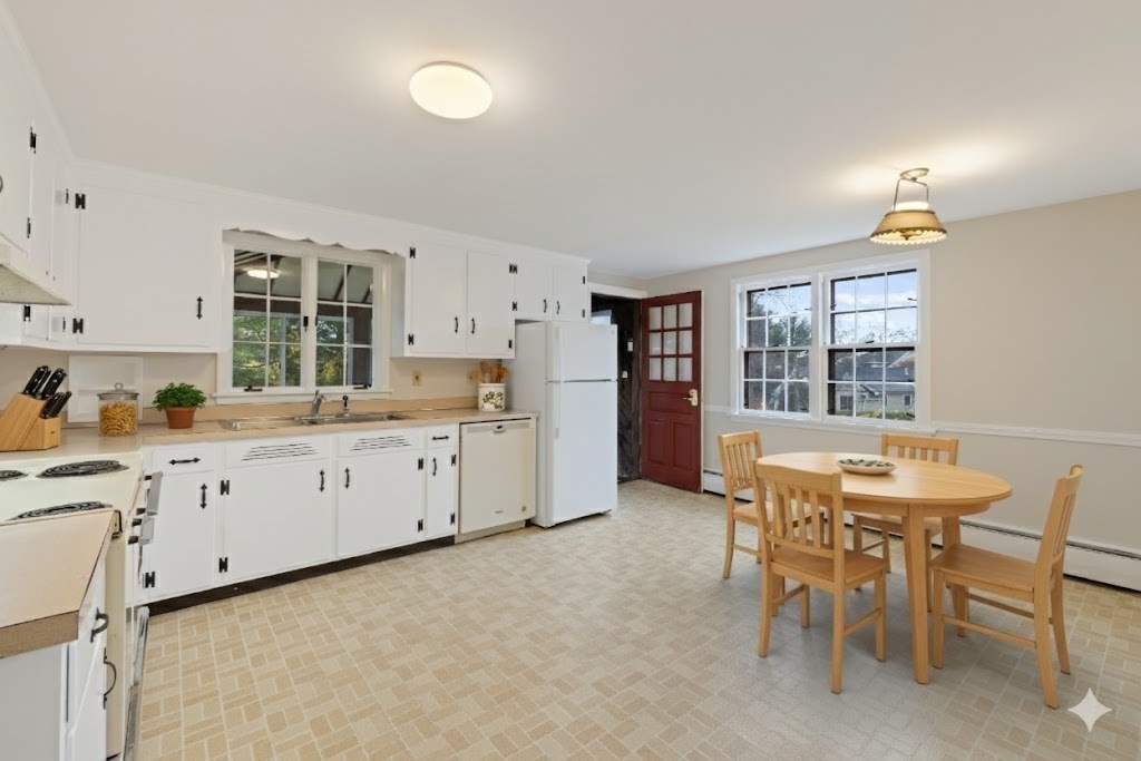 45 Peach Highlands Marblehead, MA 01945 - Photo 5 of 21 a kitchen with granite countertop white cabinets and stainless steel appliances