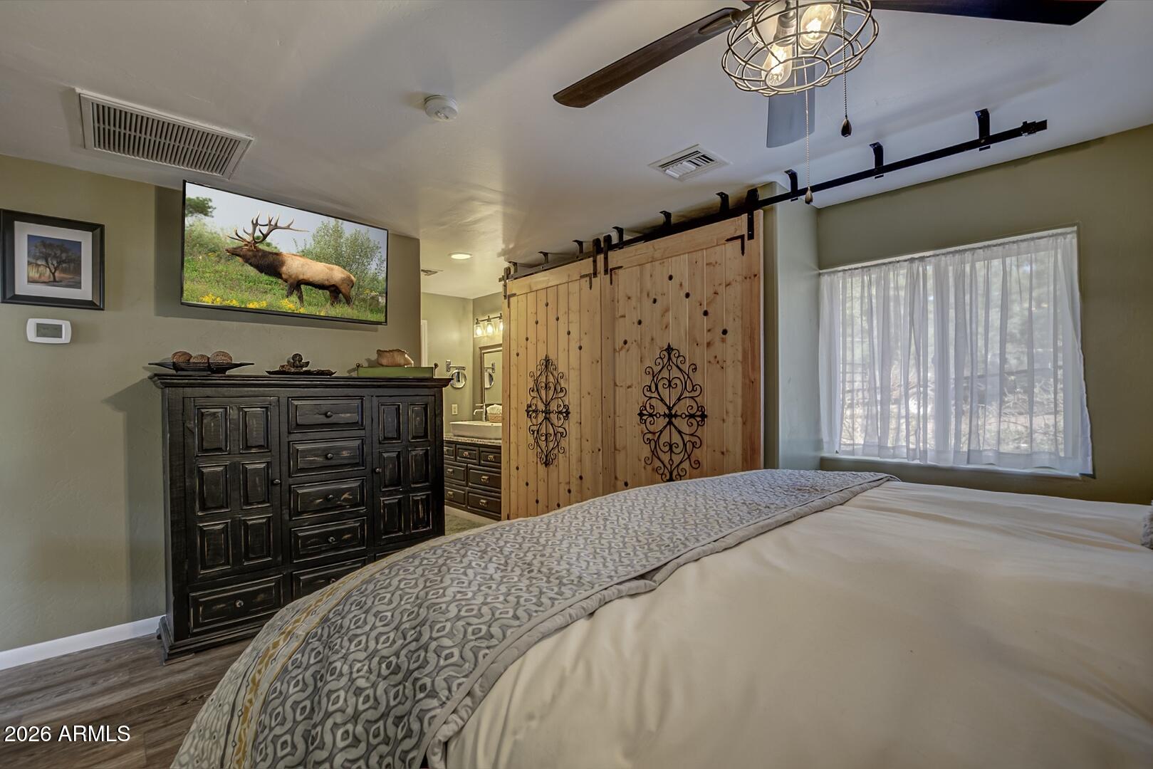 3762 Watertank Road Pine, AZ 85544 - Photo 15 of 38 a bedroom with a bed and a flat screen tv