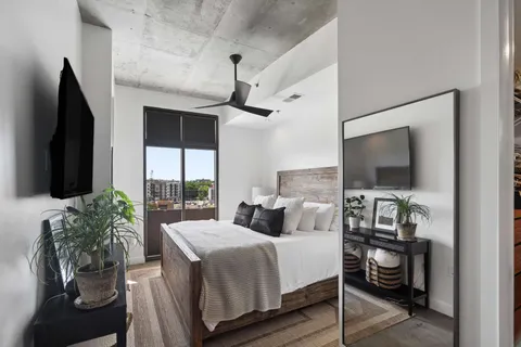 a bedroom with a bed and a flat screen tv
