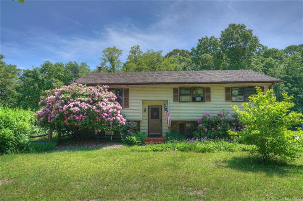 8 Deer Ridge Road Stonington, CT 06378 - Photo 1 of 1 a front view of a house with garden