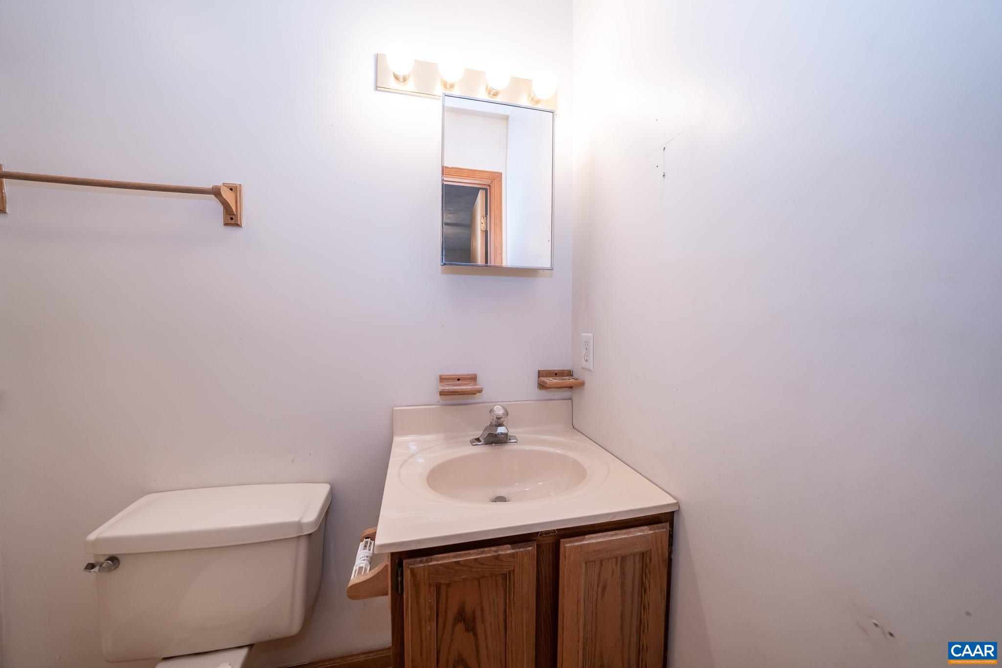 49 Chestnut Ridge Road Staunton, VA 24401 - Photo 23 of 55 a bathroom with a toilet sink and mirror