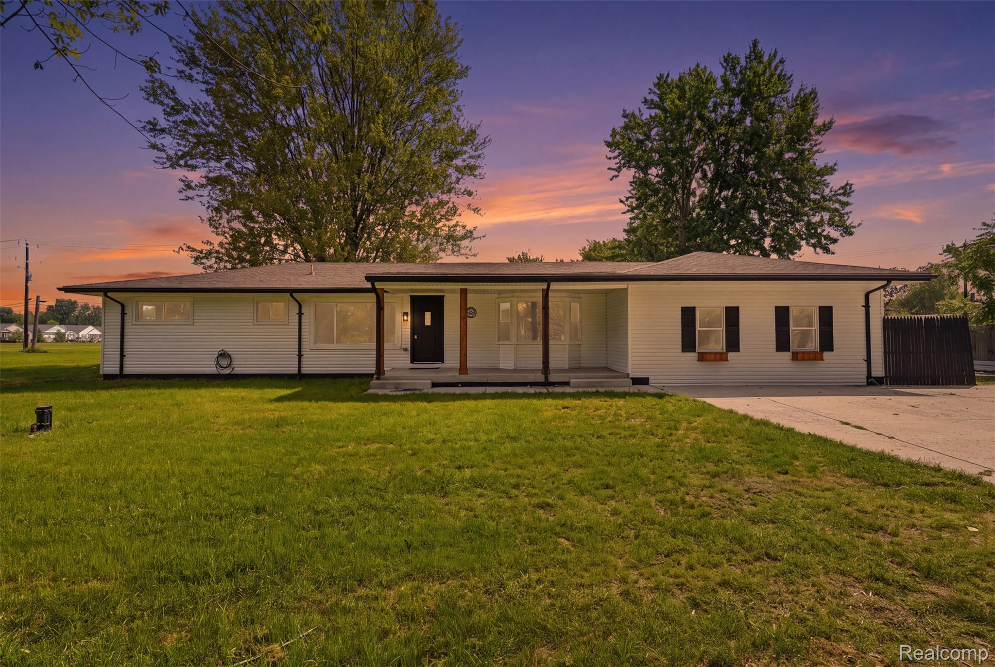 4655 Denton Road Canton, MI 48188 - Photo 51 of 54 White siding exterior with a dark front door, covered entry porch, and black window shutters