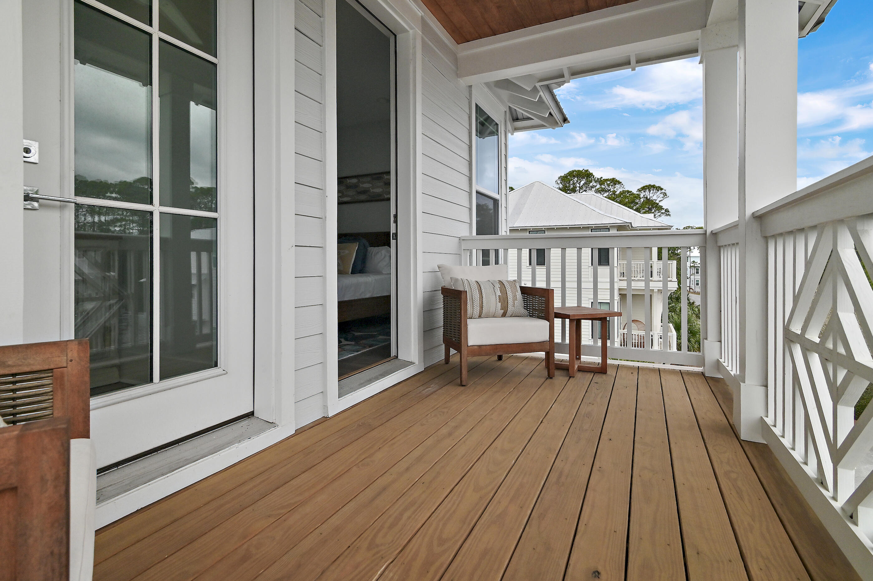 171 Redbud Ln Inlet Beach Inlet Beach, FL 32461 - Photo 31 of 37 a balcony with wooden floor table and chairs