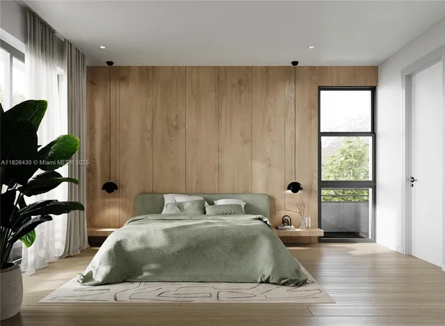 a bedroom with a bed and a large window