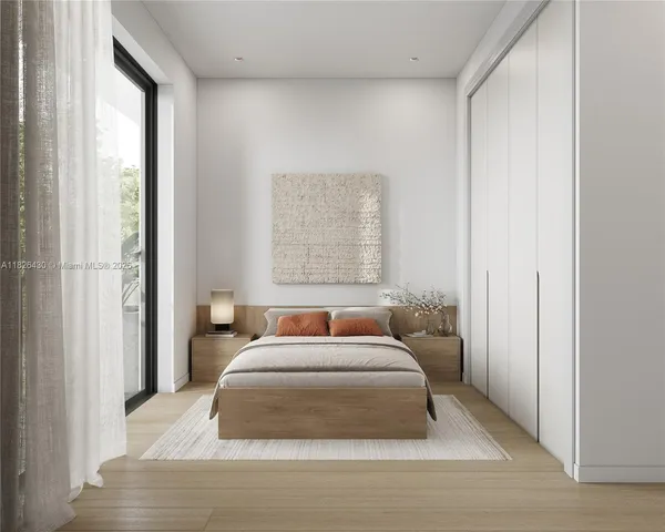 a bedroom with a large bed and a window