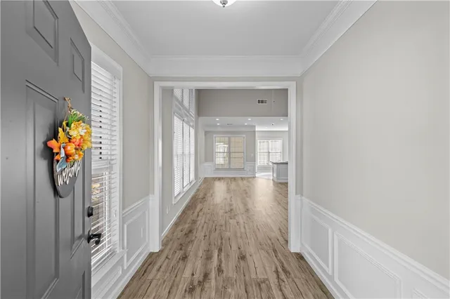 a view of a hallway with wooden floor and staircase