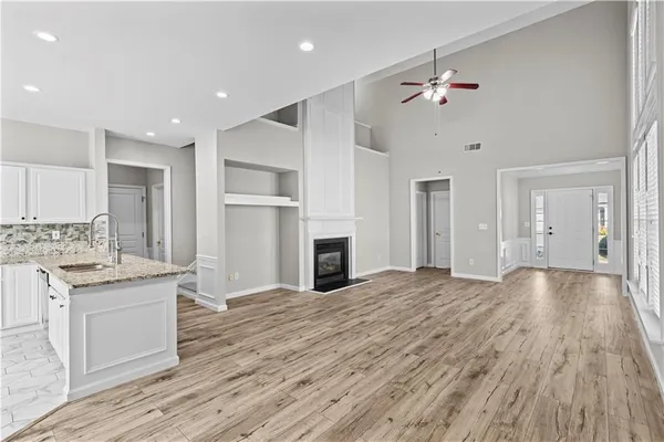 a view of a kitchen with a sink cabinets and wooden floor